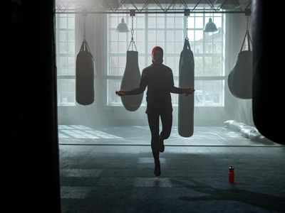 Silhouette of a person jumping in a gym